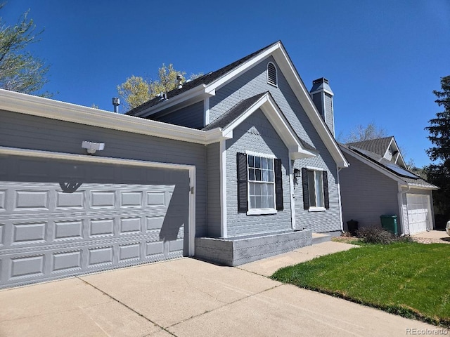 17605 E Temple Dr, Aurora, CO 80015 - view of front of home with concrete driveway, a chimney, and a garage