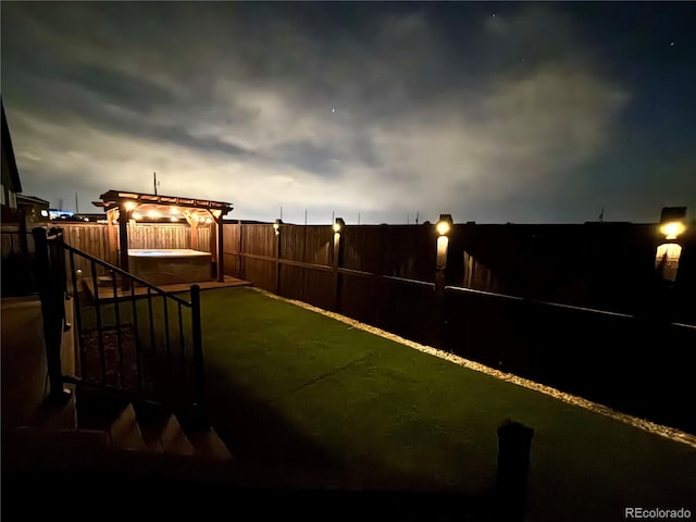 view of yard featuring a fenced backyard and a hot tub