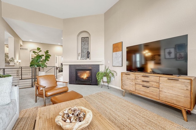 sitting room with light carpet and a tile fireplace