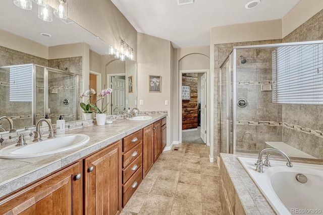 bathroom with vanity and separate shower and tub