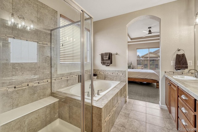 bathroom featuring tile patterned flooring, shower with separate bathtub, vanity, and ceiling fan