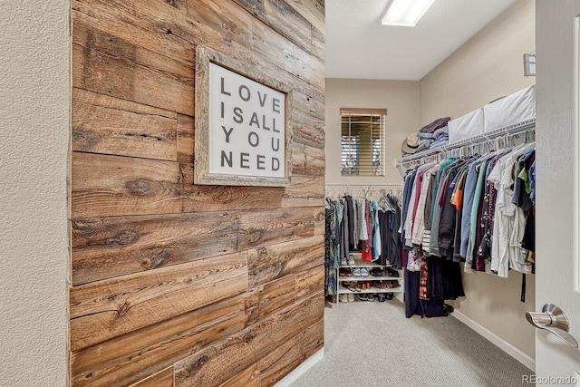 walk in closet with carpet flooring