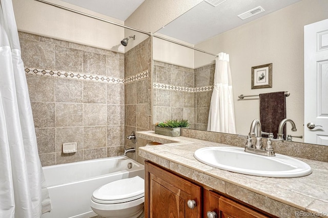 full bathroom with vanity, shower / tub combo, and toilet