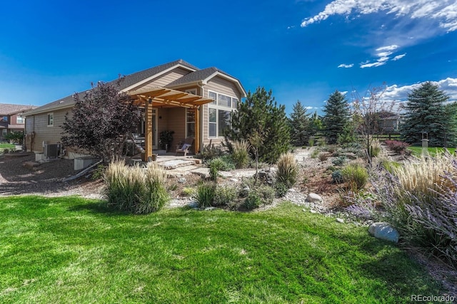 view of front facade featuring a front yard, a patio, cooling unit, and a pergola