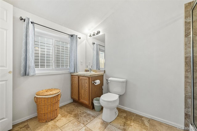 bathroom featuring vanity, toilet, a shower, and vaulted ceiling