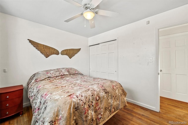 bedroom with ceiling fan, a closet, and hardwood / wood-style flooring