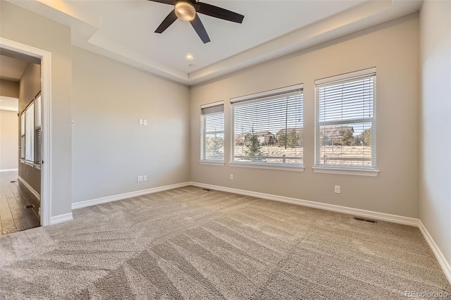 spare room featuring ceiling fan, recessed lighting, visible vents, baseboards, and a raised ceiling