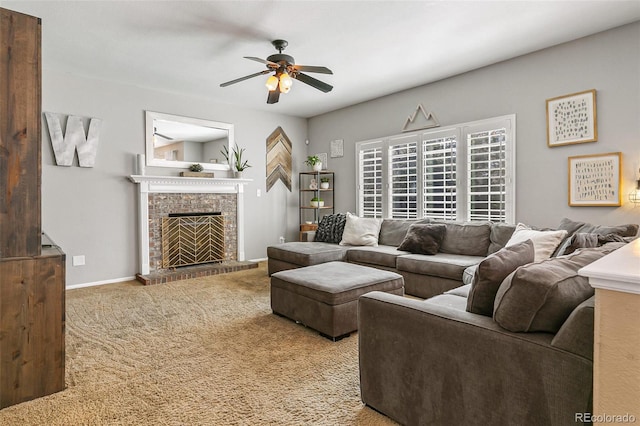 carpeted living area with ceiling fan, baseboards, and a fireplace