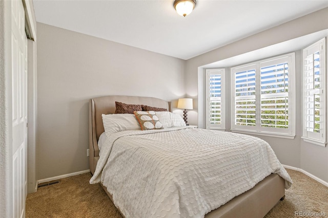 bedroom featuring carpet flooring, visible vents, and baseboards