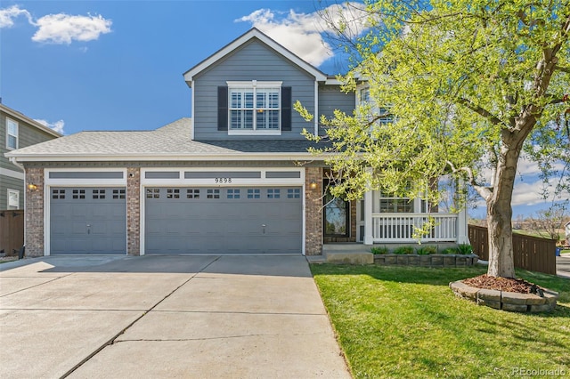 traditional-style home featuring brick siding, a front lawn, driveway, and a porch