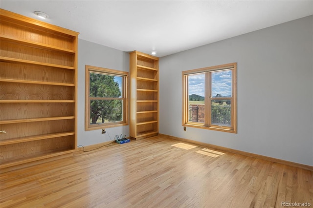 1680 Elk View Rd, Larkspur, CO 80118 - empty room featuring wood finished floors and healthy amount of natural light
