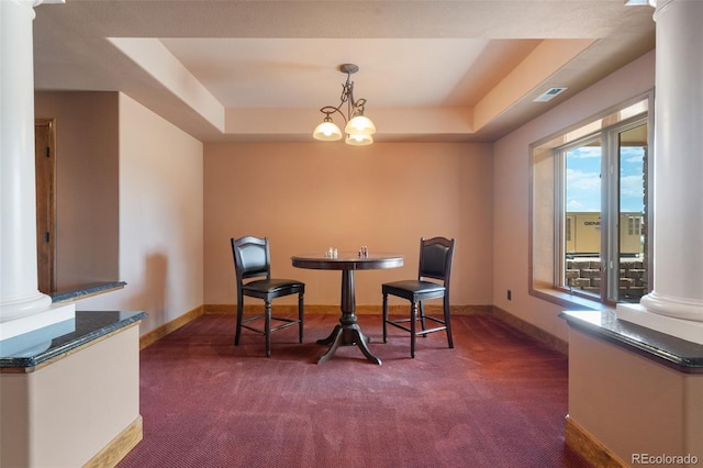 1680 Elk View Rd, Larkspur, CO 80118 - dining space featuring dark carpet, decorative columns, a raised ceiling, and a chandelier