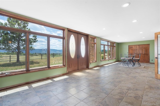 1680 Elk View Rd, Larkspur, CO 80118 - foyer entrance featuring plenty of natural light, recessed lighting, and a mountain view