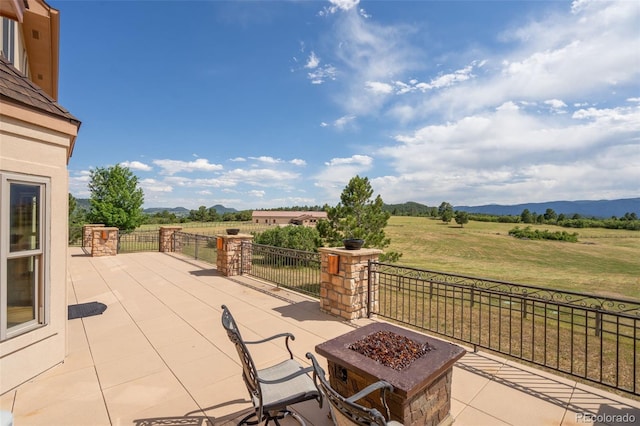 1680 Elk View Rd, Larkspur, CO 80118 - view of patio / terrace with a fire pit, a view of rural / pastoral area, and a mountain view