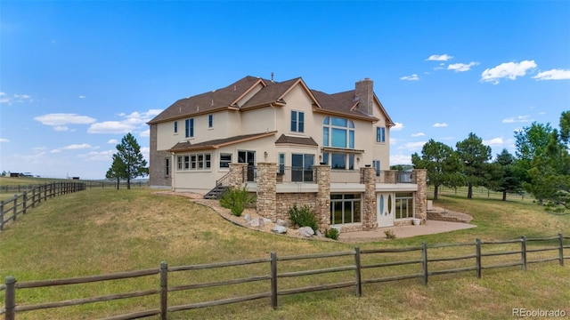 1680 Elk View Rd, Larkspur, CO 80118 - rear view of house with stucco siding, stone siding, a chimney, a fenced backyard, and a patio