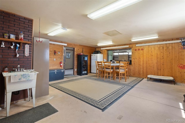 1680 Elk View Rd, Larkspur, CO 80118 - miscellaneous room featuring wood walls, concrete flooring, and attic access