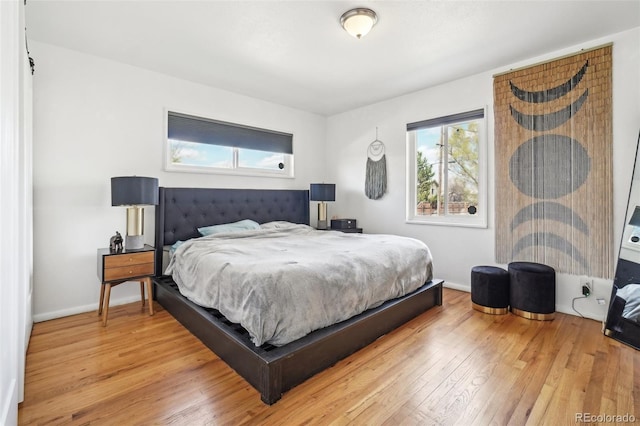 bedroom with baseboards and light wood-style floors