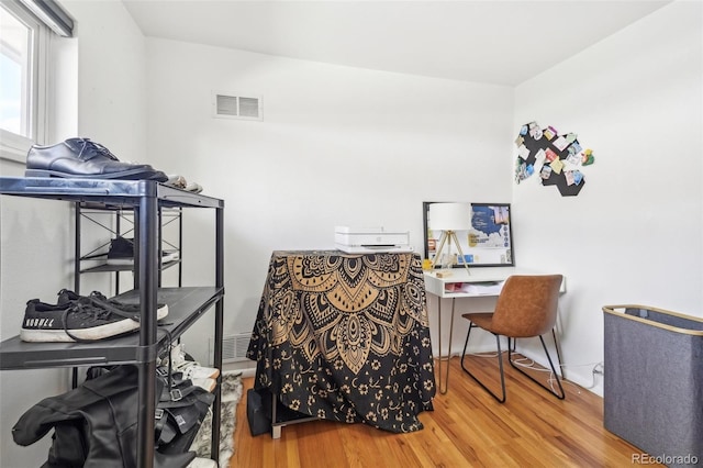 office featuring visible vents and wood finished floors