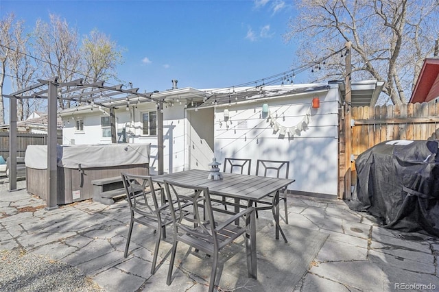 view of patio with a pergola, a hot tub, grilling area, fence, and outdoor dining area