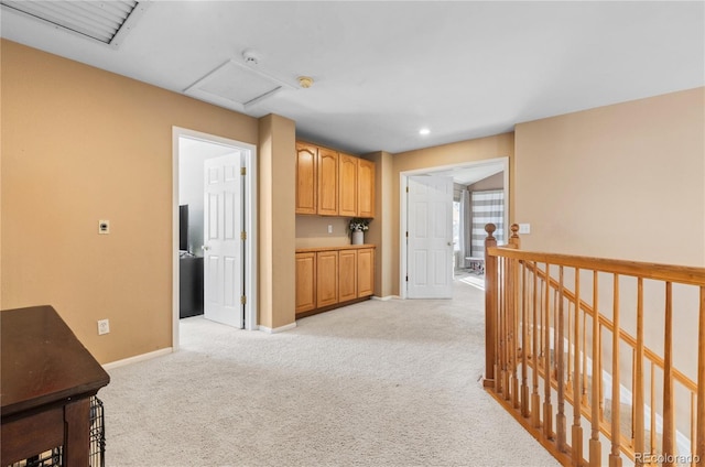 corridor featuring light carpet, attic access, baseboards, an upstairs landing, and recessed lighting