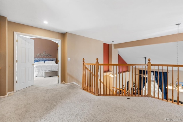 corridor featuring recessed lighting, carpet floors, an upstairs landing, baseboards, and vaulted ceiling