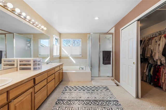 full bath featuring a stall shower, a garden tub, a sink, and double vanity