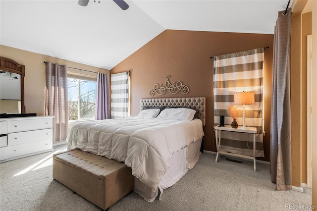 bedroom featuring a ceiling fan, lofted ceiling, and light carpet