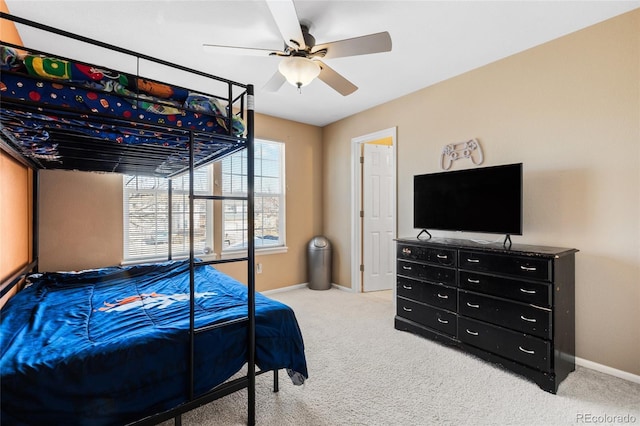 bedroom featuring ceiling fan, baseboards, and light colored carpet