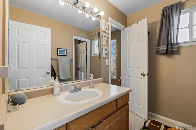 bathroom featuring baseboards and vanity