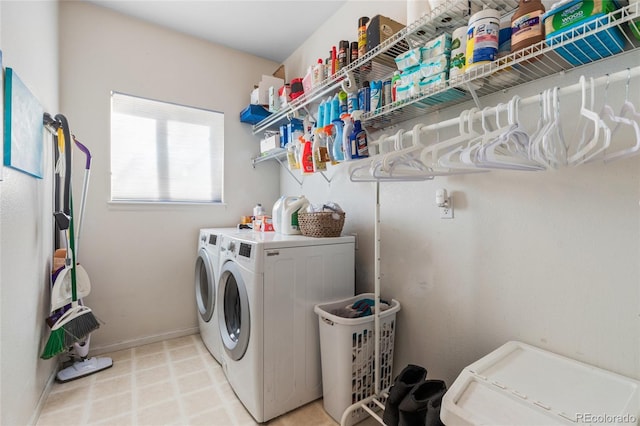 clothes washing area featuring laundry area, baseboards, and separate washer and dryer