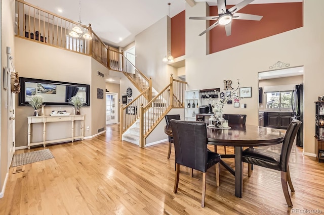 13277 Elizabeth St, Thornton, CO 80241 - dining area with high vaulted ceiling, stairway, ceiling fan, and wood finished floors