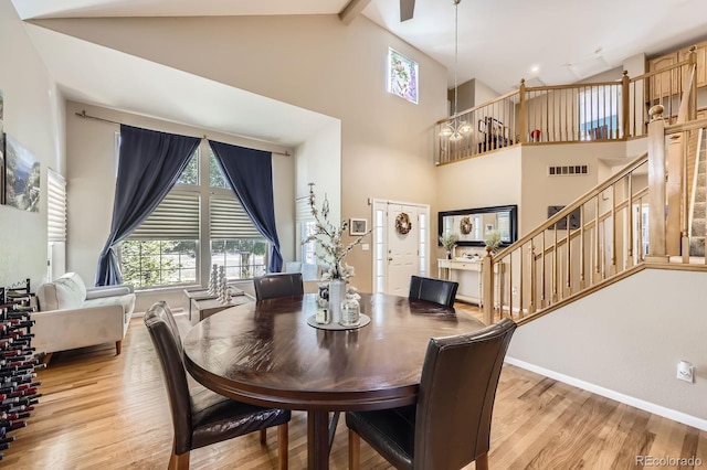13277 Elizabeth St, Thornton, CO 80241 - dining room with light wood finished floors, stairway, and high vaulted ceiling