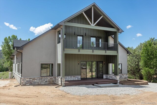7916 Cozart Ln, Salida, CO 81201 - rear view of house with a balcony, stone siding, board and batten siding, stucco siding, and a porch
