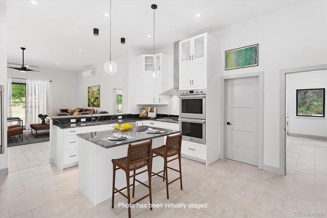 7916 Cozart Ln, Salida, CO 81201 - kitchen featuring a peninsula, stainless steel appliances, glass insert cabinets, white cabinets, and recessed lighting