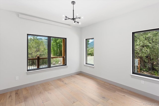 7916 Cozart Ln, Salida, CO 81201 - spare room featuring a chandelier and light wood finished floors