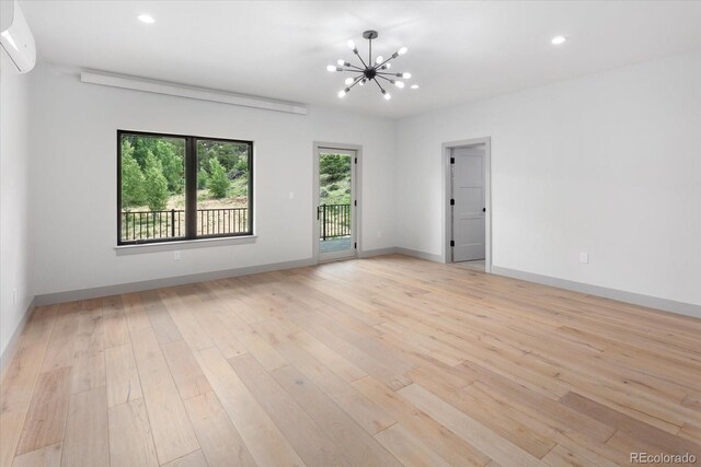 7916 Cozart Ln, Salida, CO 81201 - spare room featuring a wall mounted AC, a chandelier, light wood finished floors, and recessed lighting