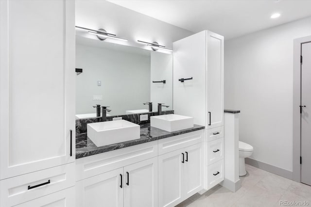 7916 Cozart Ln, Salida, CO 81201 - full bathroom featuring double vanity, recessed lighting, and marble look tile flooring