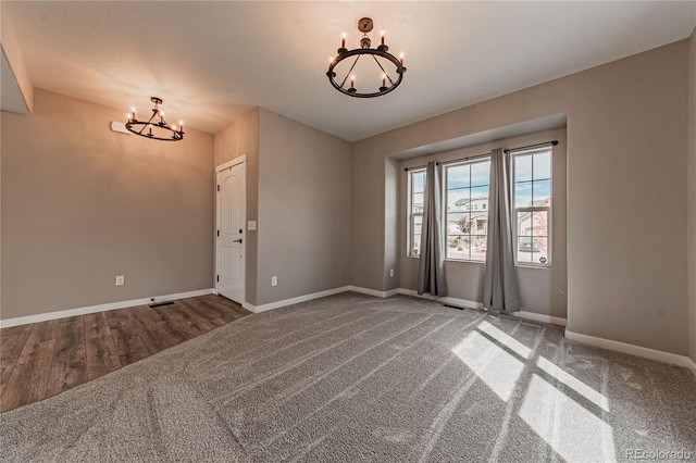 unfurnished room featuring an inviting chandelier and carpet floors