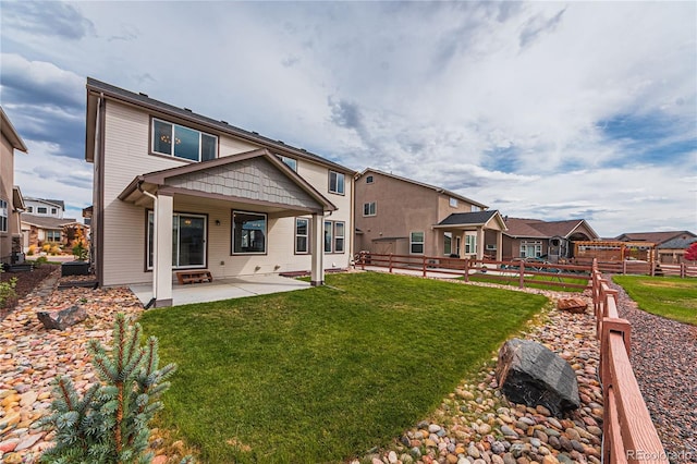 back of house featuring a yard and a patio area