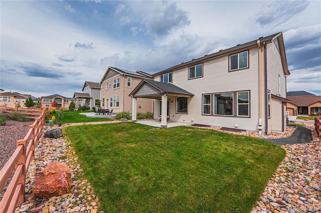 back of property featuring a yard and a patio area