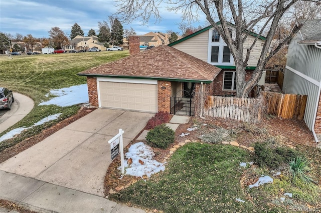 view of property with a garage and a front yard