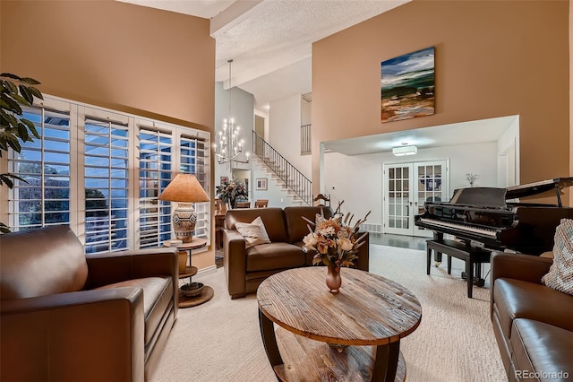 living room featuring french doors, a textured ceiling, high vaulted ceiling, a chandelier, and carpet floors