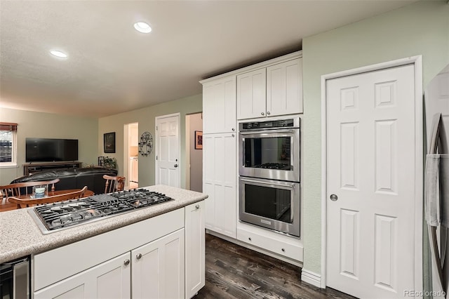 kitchen with wine cooler, white cabinetry, dark wood-type flooring, and appliances with stainless steel finishes