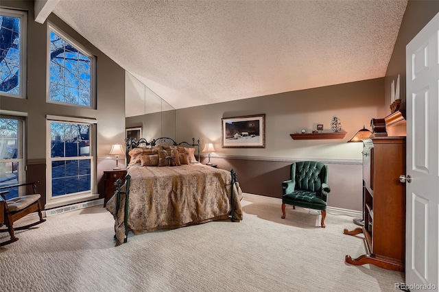 carpeted bedroom with beam ceiling, a textured ceiling, and high vaulted ceiling