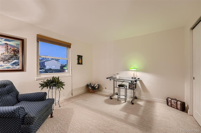 sitting room featuring light colored carpet