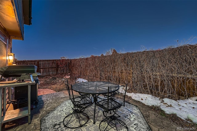 snow covered patio with area for grilling