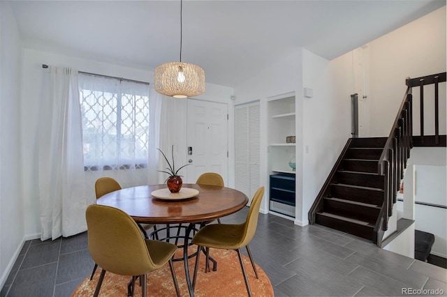 dining space with baseboards and stairway