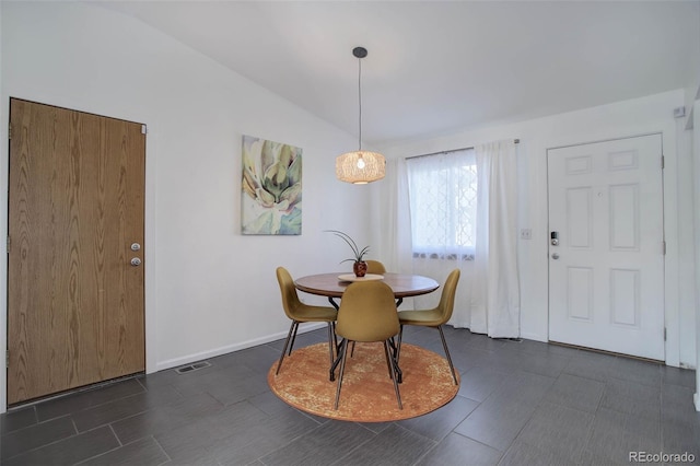 dining space with visible vents, vaulted ceiling, and baseboards