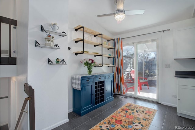 interior space featuring ceiling fan and baseboards