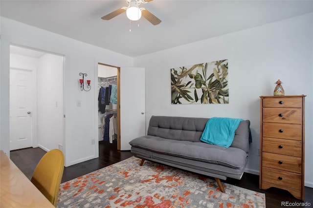 interior space featuring a ceiling fan, baseboards, and wood finished floors